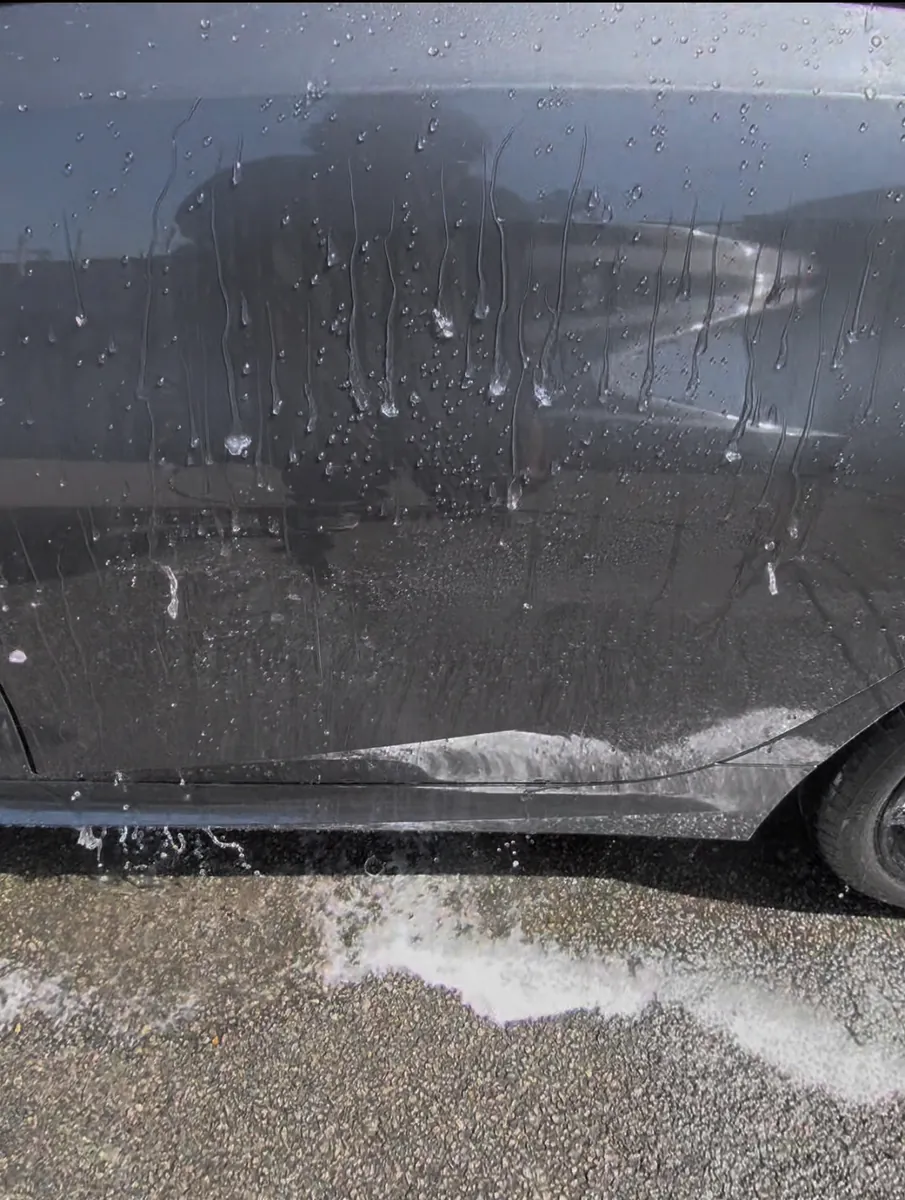 Water beading on a ceramic coated car door in Wembley