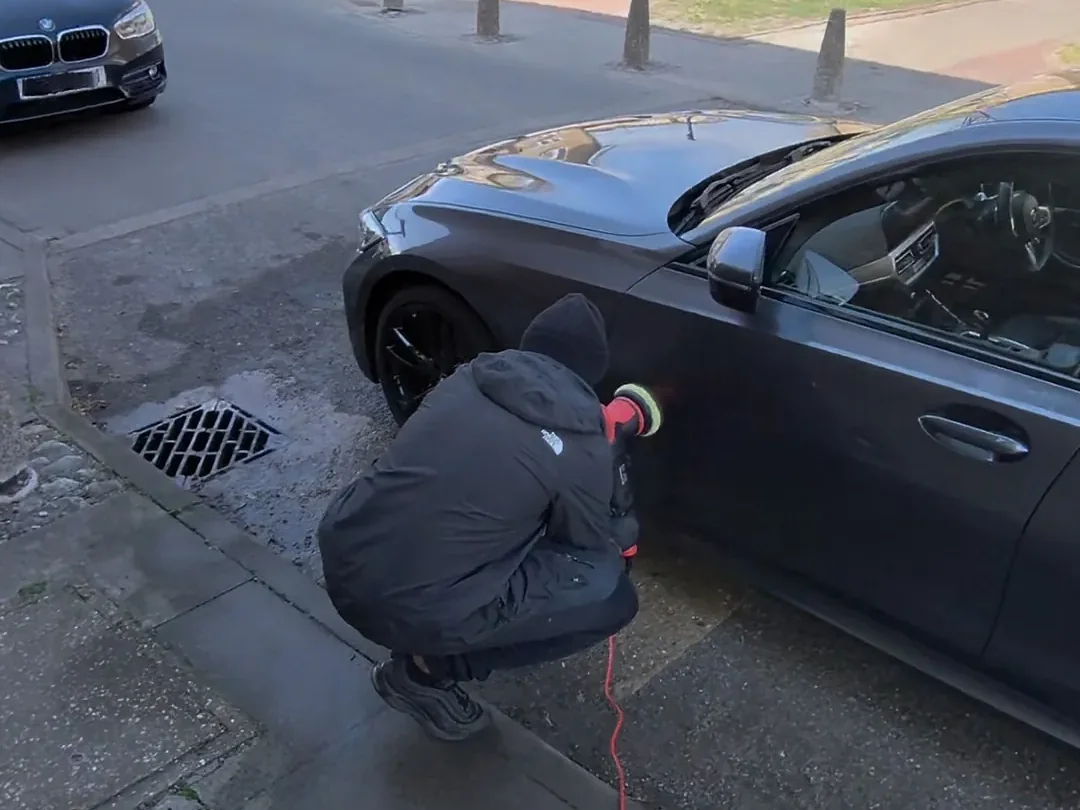 Mobile paint correction machine polishing a BMW on a street in NW London